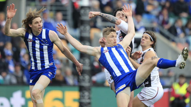 Off kilter: Jack Ziebell tries to find his feet in a contest as North forward Ben Brown looks on.