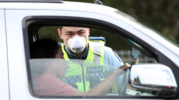 The pandemic has altered the economic outlook: NZ Police stop motorists at a checkpoint in Auckland to ensure residents are complying with the coronavirus lockdown.