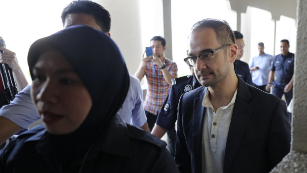 Riza Aziz, right, Hollywood producer and stepson of Malaysian former PM Najib Razak, walks into the Kuala Lumpur High Court on Friday.