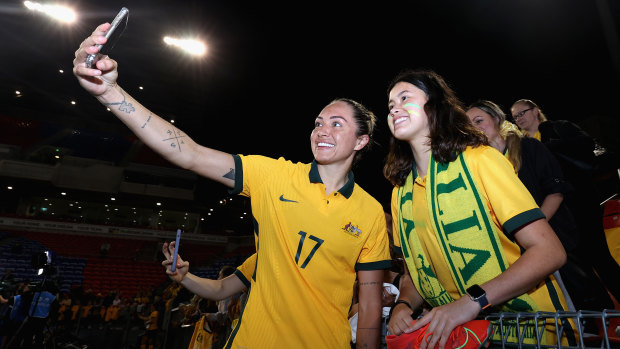 Kyah Simon poses with fans after the second international against the USA in Newcastle.