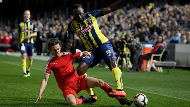 Wing man: Usain Bolt is tackled by Daniel Bird.