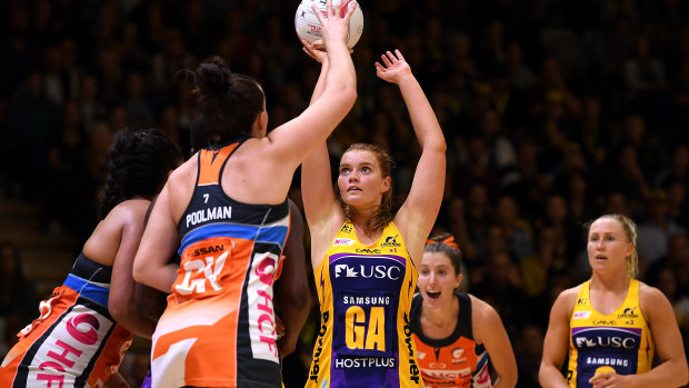 Lightning's Stephanie Wood (centre) helped her side to a fourth consecutive win.