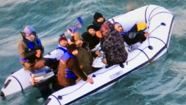 Migrants aboard a rubber boat after being intercepted by French authorities off the port of Calais in northern France.