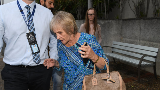The grandmother of Kyesha Finemore and her sister Tayla Finemore (at rear), leave the Magistrates Court in Beenleigh, south of Brisbane, on Friday. 
