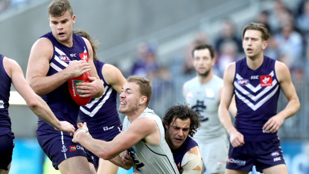 Contested possession: Sean Darcy takes a grab under pressure for the Dockers.