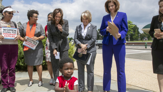 A child of an immigrant joins applause as Senator Kamala Harris, joined by Governor Michelle Lujan Grisham and Senator Catherine Cortez Masto, protest against threats by President Donald Trump against asylum seekers in 2018.