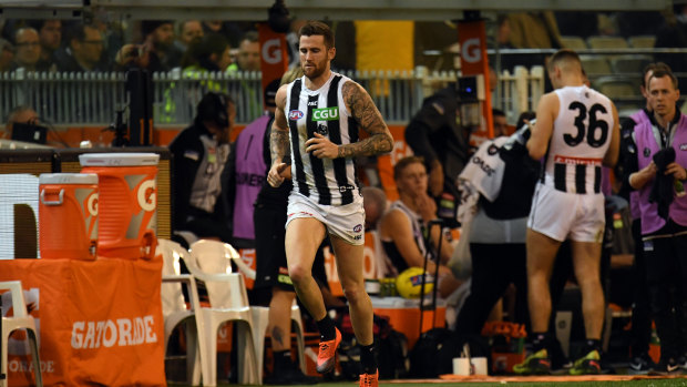 Jeremy Howe of the Magpies (left) is seen after sustaining an injury during the  Preliminary Final. 
