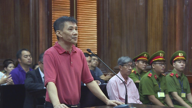 Michael Nguyen stands during his trial in Ho Chin Minh City, Vietnam. 