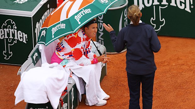 Victoria Azarenka of Belarus speaks with a match official during a rain break in her first-round match.