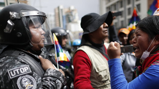 Protests continue: A supporter of Bolivia's former president Evo Morales yells at a police officer to respect the nation's indigenous people in La Paz, Bolivia.