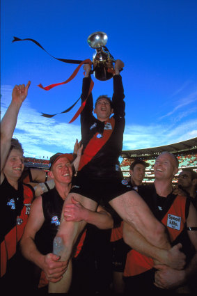 Then Essendon skipper James Hird holds the 2000 premiership cup aloft.