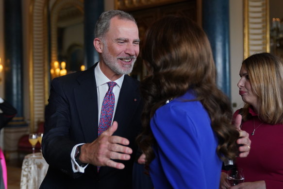King Felipe VI of Spain welcomes Catherine, Princess of Wales, at a reception at Buckingham Palace.