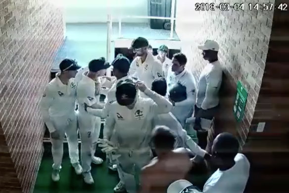 Members of the Australian cricket restrain David Warner during the first Test in Durban four years ago.