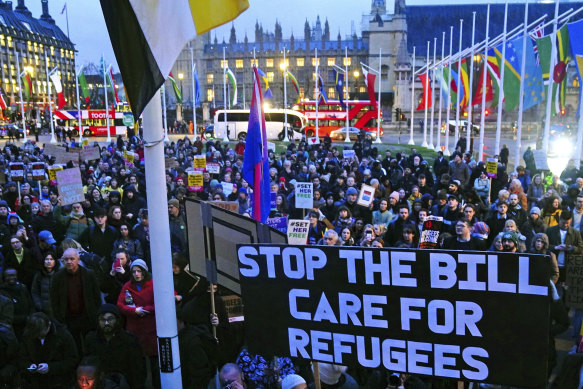 People gather in Parliament Square, London, to protest the Illegal Migration Bill during its second reading in the House of Commons on Monday.