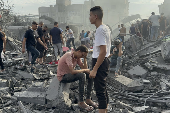 Palestinians look for survivors following Israeli airstrike in Nusseirat refugee camp, Gaza.