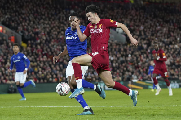 Liverpool's teen sensation Curtis Jones, right, challenges for the ball with Everton's Yerry Mina. 