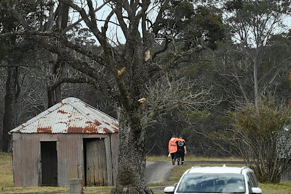 Jim Hooper (left) is embraced as he walks towards the search area.