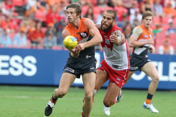 Callan Ward is chased down by Lance Franklin.