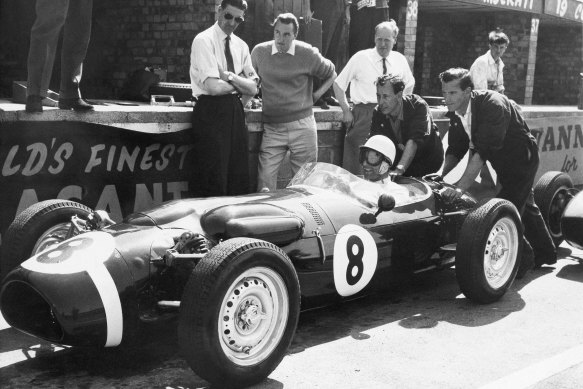 Stirling Moss, at the wheel of the revolutionary new Ferguson racing car in 1961, gets a shove off from mechanics as he takes practice laps at Silverstone, England. 