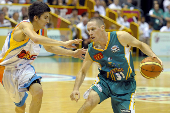 John Rillie, right, in action for the Townsville Crocodiles during his playing days. 