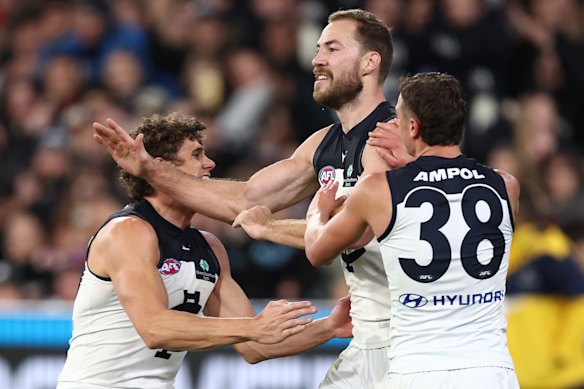Harry McKay celebrates a goal with Charlie Curnow and Will White.