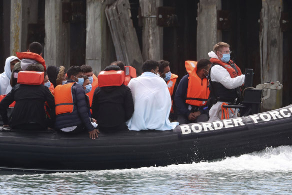 A British Border Force vessel carries a group of men thought to be migrants into Dover harbour, Southern England, last week. 