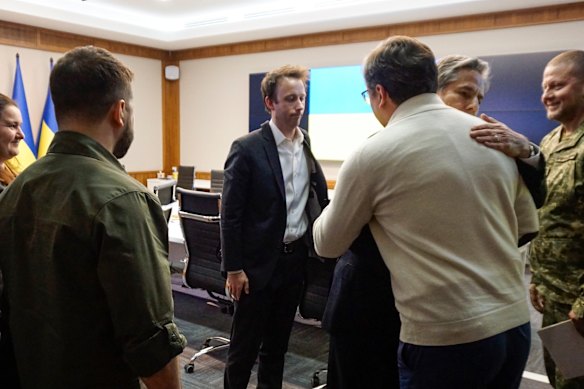 Volodymyr Zelensky looks on as Us Secretary of State Antony Blinken embraces Ukraine’s Foreign Minister Dmytro Kuleba. 