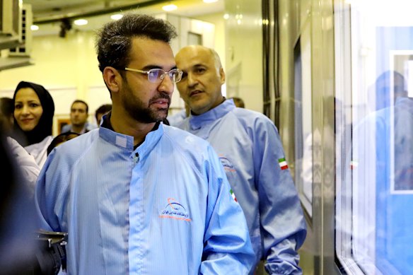 Iran's Minister of Information and Communications Technology Mohammad Javad Azari Jahromi looks at The Nahid-1 domestically-built satellite at the space research center in Tehran, Iran. 
