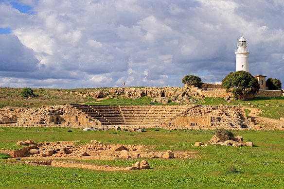 The Odeion (small Roman theatre) and the modern lighthouse within the Paphos Archaeological Park in Cyprus.