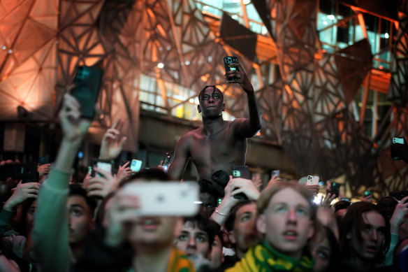 Fans are seen at Federation Square on Thursday morning. 