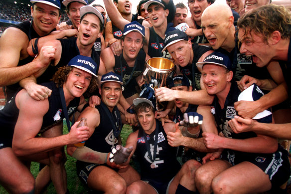The Blues celebrate with the 1995 premiership cup.