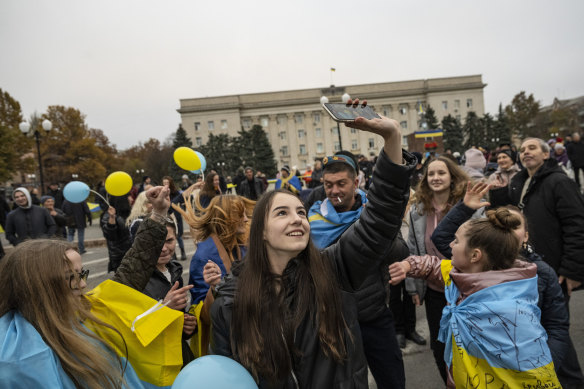 Ukrainian civilians and soldiers rejoice over the liberation of Kherson in the city’s main square, after Russia formally announced its retreat, in southern Ukraine on Saturday, November 12.
