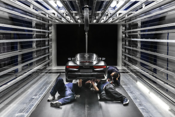 Engineers work on a scaled version of the Maserati MC20 during wind tunnel testing.