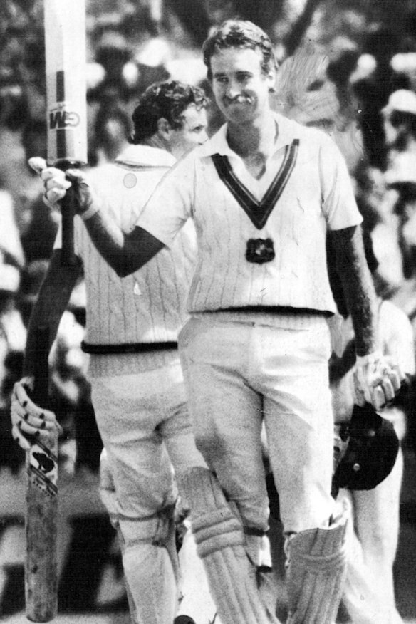 Wayne Phillips waves his bat to the crowd after completing his maiden century in 1983.