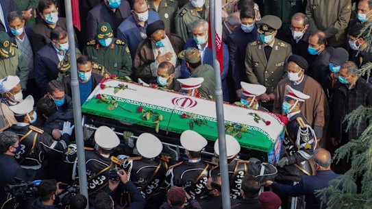 Military personnel carry the flag-draped coffin of Mohsen Fakhrizadeh at his funeral on Monday.