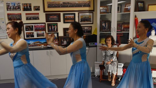 Mrs Zhang watches on as the dance group perform their moves.