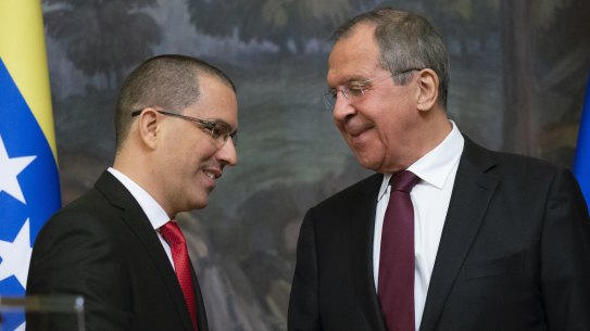 Russian Foreign Minister Sergey Lavrov, right, and Venezuelan Foreign Minister Jorge Arreaza shake hands after their joint news conference following the talks in Moscow.