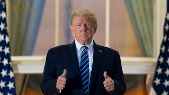 All thumbs ... President Donald Trump on the Blue Room Balcony upon returning to the White House. 