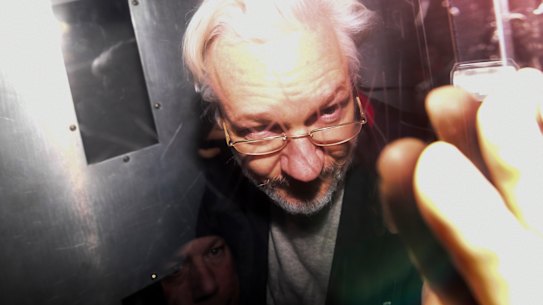Julian Assange leaves in a prison van after appearing in a London court last year.