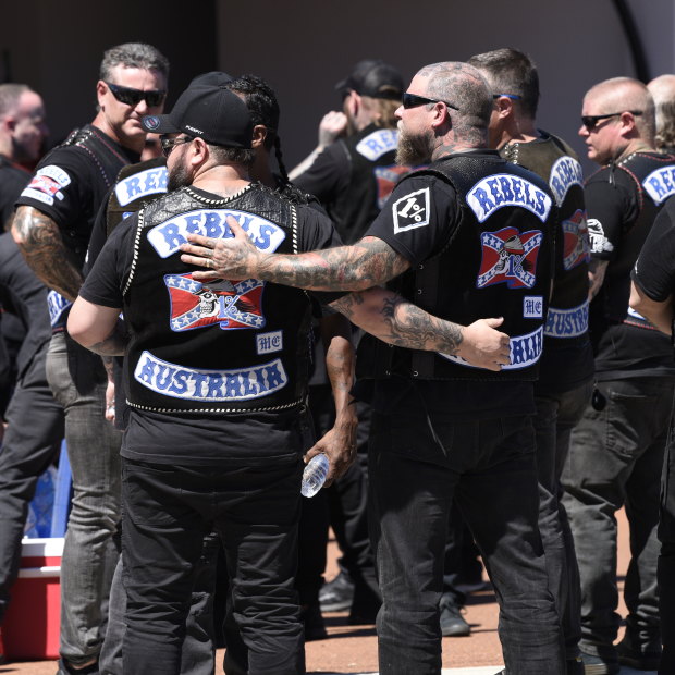 Rebels MC members embrace outside of the North Perth funeral where the body of slain boss Nick Martin is being kept. 