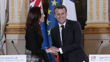 New Zealand Prime Minister Jacinda Ardern, left, and French President Emmanuel Macron shake hands after the Christchurch Call to Action conference in Paris.