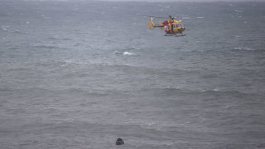 Search crews look for survivors after an upturned dinghy was spotted in the water.  