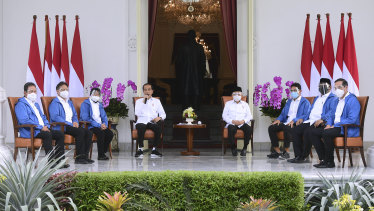President Joko Widodo, centre-left, and his deputy Ma'ruf Amin, centre-right, introduce his newly appointed cabinet ministers.