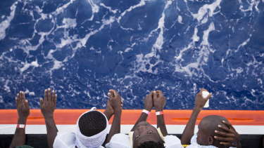African migrants stand on the deck of the Aquarius in August.