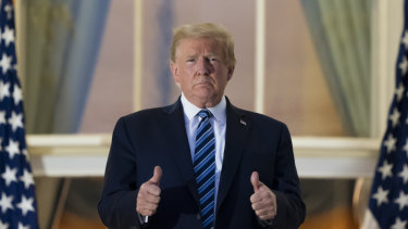 All thumbs ... President Donald Trump on the Blue Room Balcony upon returning to the White House. 