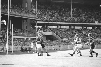 Footscray ruckman rises over Graham Cooper and Graham Ion.