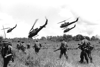 Australian soldiers of the 1st Battalion scatter for cover after landing from helicopters in Vietnam.