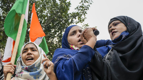 Indian Muslim women shout slogans during a protest against banning Muslim girls wearing hijab from attending classes at some schools in the southern Indian state of Karnataka.