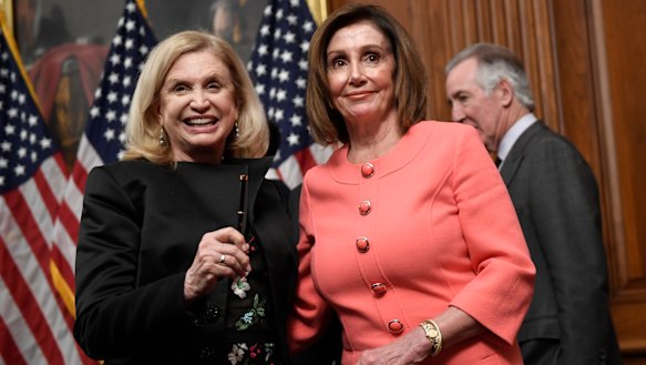 House Speaker Nancy Pelosi stands with House Oversight and Government Reform Committee Chair Representative Carolyn Maloney, left, after she signed the resolution to transmit the two articles of impeachment against President Donald Trump to the Senate for trial on Capitol Hill in Washington. 