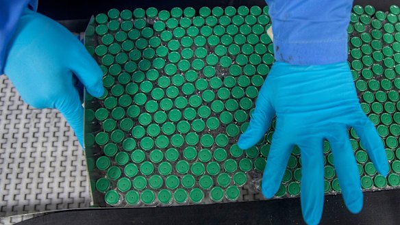 An employee packs a box containing vials of Covishield, a version of the AstraZeneca vaccine, at the Serum Institute of India in Pune.